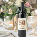 50th birthday floral rose gold eucalyptus monogram wine label<br><div class="desc">For an elegant and feminine 50th birthday birthday party. A golden watercolored background. Decorated with a rose gold and blush pink watercolored rose flower, floral, green eucalyptus leaves, sprigs, greenery and faux gold sprigs. Personalise and a name. Black and golden letters. The name is written with a modern hand lettered...</div>