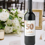 50th birthday floral rose gold eucalyptus monogram wine label<br><div class="desc">For an elegant and feminine 50th birthday birthday party. A chic white background. Decorated with a rose gold and blush pink watercolored rose flower, floral, green eucalyptus leaves, sprigs, greenery and faux gold sprigs. Personalise and a name. Black and golden letters. The name is written with a modern hand lettered...</div>