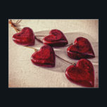 5 Red Wooden Hearts Entwined Together Postcard<br><div class="desc">5 distressed and weathered looking wooden hearts. These deep red hearts are attached to a fine rope and strung together to create a necklace pendant. These dangling hearts sit together on a cream textured background. The heart is a symbol of love,  affection,  romance and passion.</div>