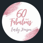 60 and Fabulous Pink Glitter 60th Birthday Classic Round Sticker<br><div class="desc">60 and Fabulous Pink Glitter 60th Birthday Stickers. Throw a stunning celebration with these “60 and Fabulous” pink glitter birthday stickers. Featuring sparkly faux-glitter brush strokes,  this elegant design is perfect for honouring a fabulous woman’s milestone birthday. Fully customisable to include a personal touch.</div>