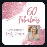60 and Fabulous Pink Glitter Photo 60th Birthday Square Sticker<br><div class="desc">60 and Fabulous Pink Glitter Photo Surprise 60th Birthday Sticker. Stunning personalised stickers with “60 and Fabulous” text and pink glitter design. Featuring sparkly faux-glitter brush strokes, and space for a personal photo, this elegant design is perfect for honouring a fabulous woman’s milestone birthday. Fully customisable to include a personal...</div>