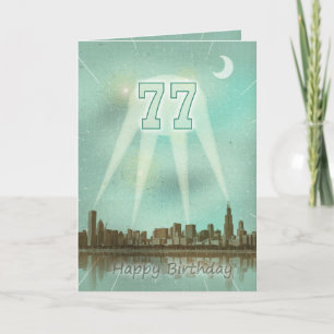 77th Birthday card with a city and spotlights