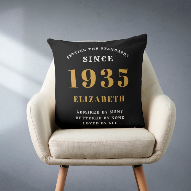 90th Birthday 1935 Black Gold lady's Personalised Cushion (Personalized 90 birthday throw pillow on a chair.)