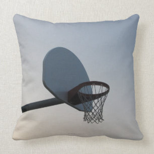 A basketball backboard hoop and net. Clear blue Cushion
