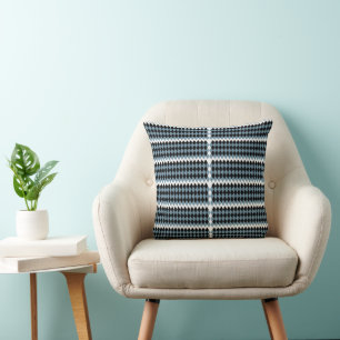 a black and white chequered pattern with a white b cushion