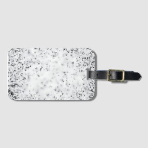 A black and white grainy texture background luggage tag