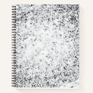 A black and white grainy texture background notebook