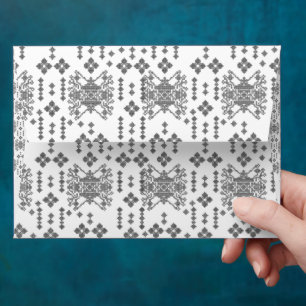 a black and white pattern with a white background envelope