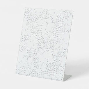 a black and white photo frame with a white backgro pedestal sign