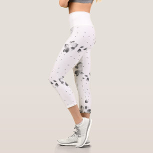 a black and white photo of a bunch of dots capri leggings