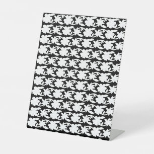 a black and white photo of a pattern pedestal sign