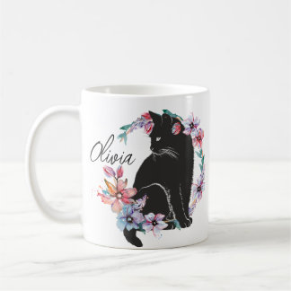 A black cat surrounded by flowers coffee mug