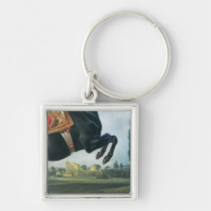 A black horse performing the Courbette Key Ring
