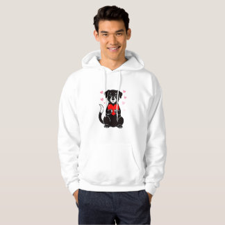 A black puppy holding a red heart hoodie