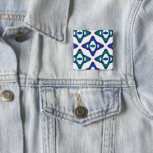 a blue and green pattern with a white background 15 cm square badge