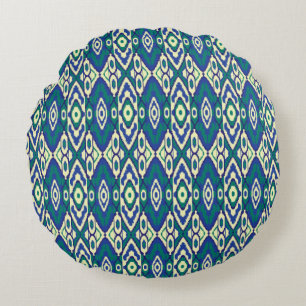 a blue and green pattern with a white background round cushion