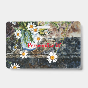 A blue and white pot of daisies on a shelf ID badge