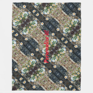 A blue and white pot of wild daisies on a shelf fleece blanket
