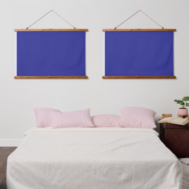 A blue background featuring a prominent white squa hanging tapestry (Bedroom)