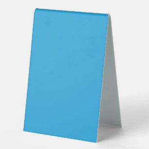 a blue background with a black and white cat