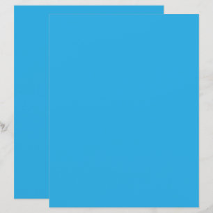 a blue background with a black and white cat on to