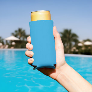 a blue background with a black and white cat on to seltzer can cooler