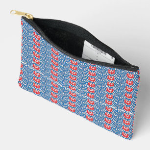 a blue background with red and white designs accessory pouch