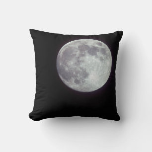 A bright full moon in a black night sky cushion