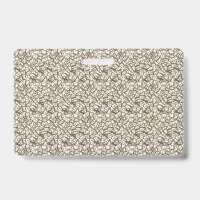 A brown rug with a geometric motif is partially co