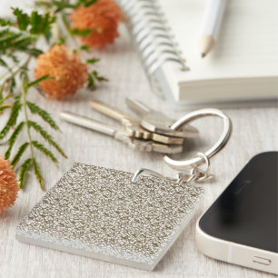 A brown rug with a geometric motif is partially co key ring