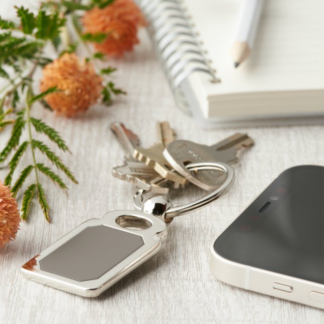 a brown wall with a black and white clock on it key ring (Side)