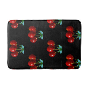 A Bunch Of Red Cherries on Stems Leaves on Black Bath Mat
