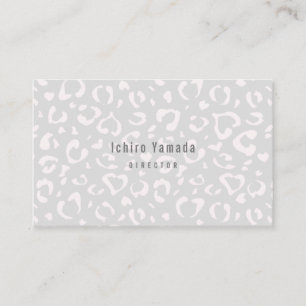 a business card with a white leopard pattern
