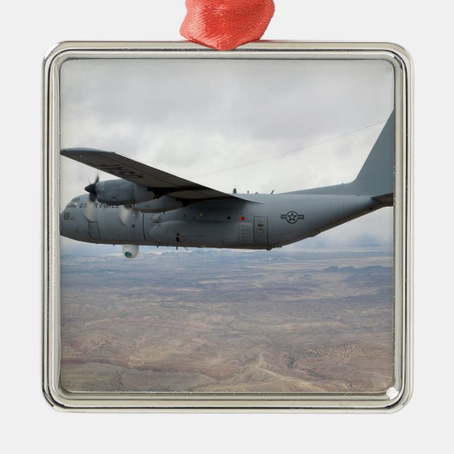 A C-130 Hercules soars through the sky Metal Ornament (Front)