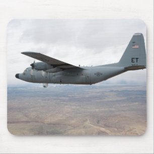 A C-130 Hercules soars through the sky Mouse Pad