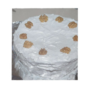 A cake with frosting notepad