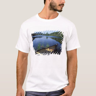 A canoe rests on the shore of Little Long Pond T-Shirt