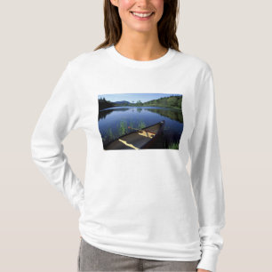 A canoe rests on the shore of Little Long Pond T-Shirt