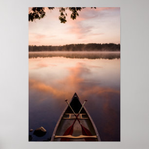 A canoe rests on the shore of Pawtuckaway Lake Poster