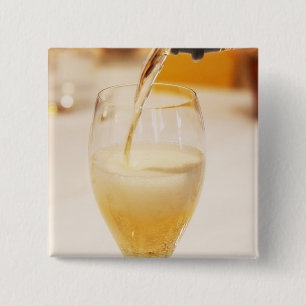 A champagne glass flute being filled with Gosset 15 Cm Square Badge