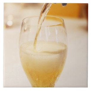 A champagne glass flute being filled with Gosset Tile