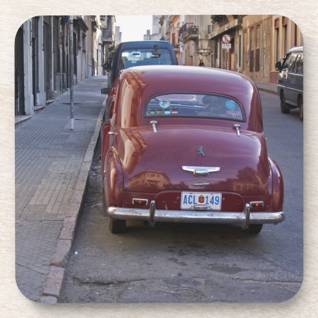 A classic old red Peugeot car parked on a street Coaster (Front)