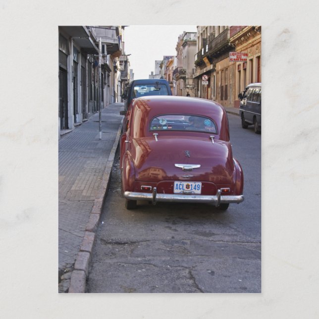 A classic old red Peugeot car parked on a street Postcard (Front)