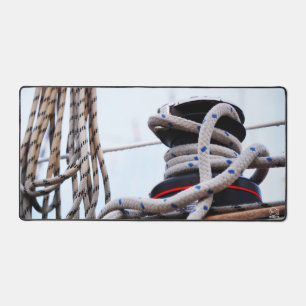 A close-up of a sailboat winch on a boat. desk mat