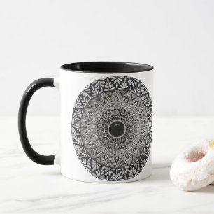 A coffee mug with monochrome mandala design