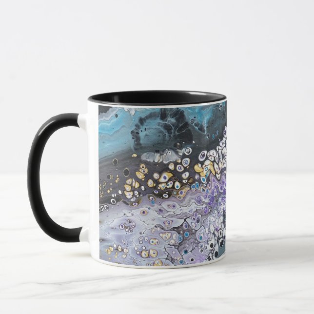 A coffee mug with purple and blue artwork (Left)