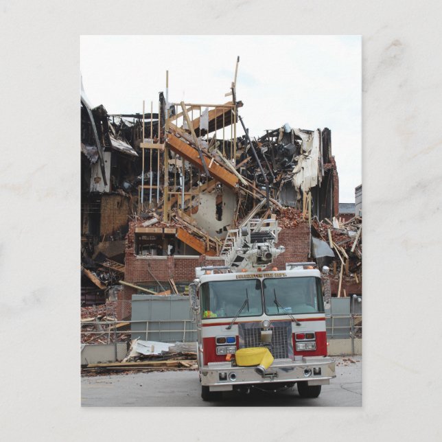 A collapsed and burnt building and a fire truck postcard (Front)