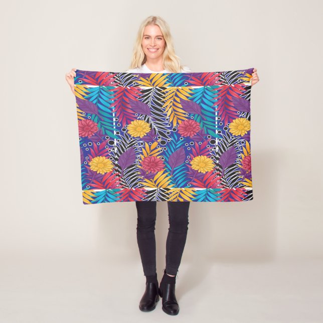 a colourful flower and leaves pattern on a blue ba fleece blanket (In Situ)