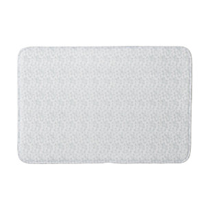 A completely white, featureless surface fills the bath mat