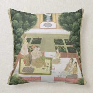 A couple in a garden listening to music with femal cushion